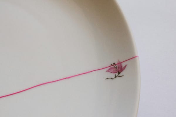 A cracked dish with a flower on it